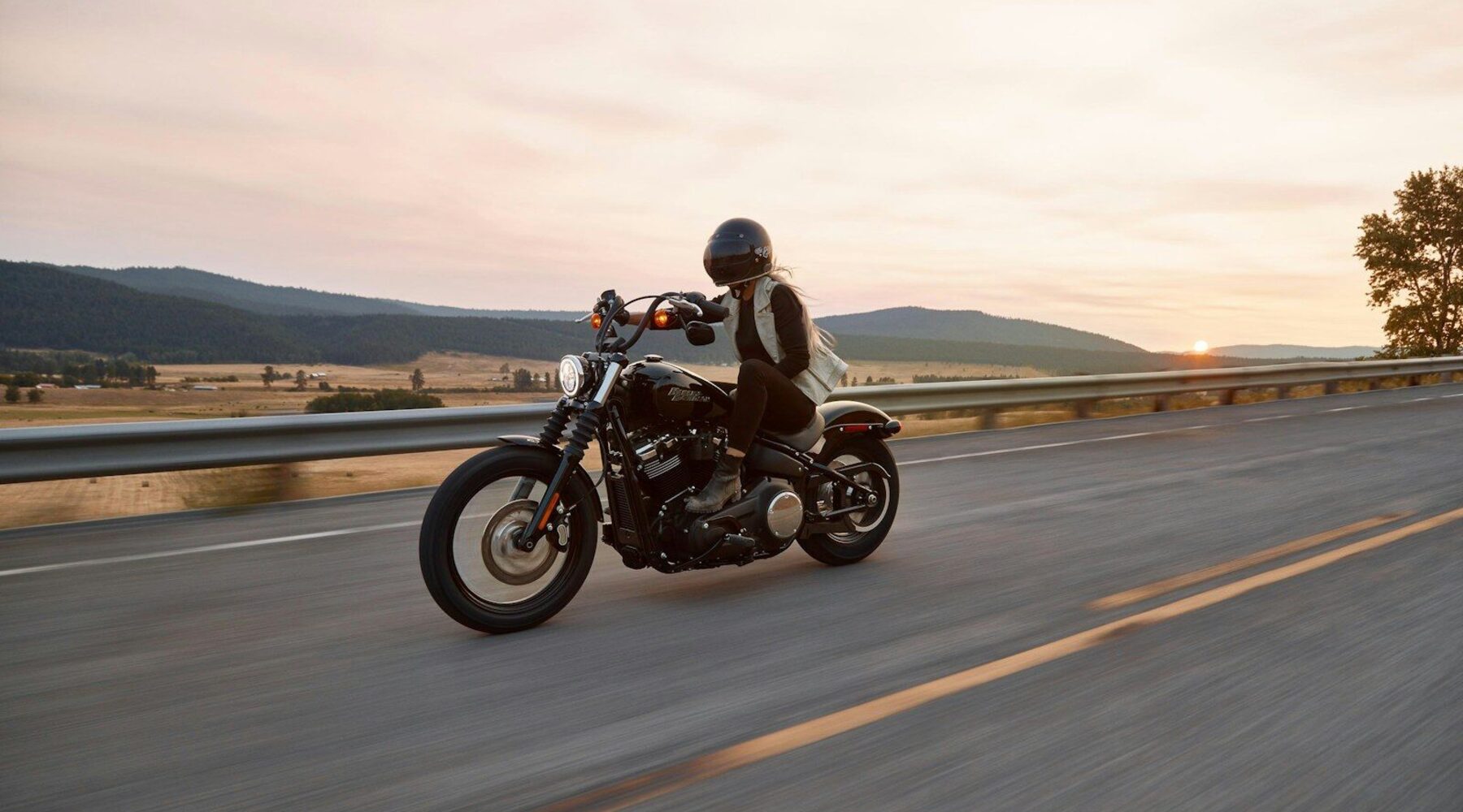 man on black cruiser motorcycle in highway